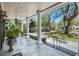 Covered porch featuring pillars, outdoor furniture, and a view of the landscaped front yard at 1911 Stonehurst Rd, Winter Park, FL 32789