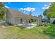 Large backyard featuring a patio area with shade, lush grass, and well-manicured landscaping at 2046 Ambergris Dr, Orlando, FL 32822