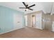 Bedroom with neutral carpet, ceiling fan, and nearby bathroom at 2046 Ambergris Dr, Orlando, FL 32822