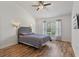 Cozy bedroom with wood floors, neutral paint, and modern sconces at 2046 Ambergris Dr, Orlando, FL 32822