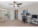 Bedroom with ceiling fan, workspace and sliding glass door, creating a spacious area at 2046 Ambergris Dr, Orlando, FL 32822