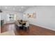 Bright dining room with wood floors, a large window, and seating for ten at 2046 Ambergris Dr, Orlando, FL 32822