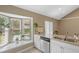 Well-lit kitchen featuring a bay window over the sink and white cabinetry at 2046 Ambergris Dr, Orlando, FL 32822