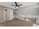 Loft area with neutral carpet and views overlooking the living room at 2046 Ambergris Dr, Orlando, FL 32822