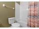 Bright bathroom features a shower-tub with a peach and gray decorative shower curtain at 2248 Wyndham Palms Way, Kissimmee, FL 34747