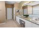 Bathroom featuring double sink vanity with well lit mirror at 2248 Wyndham Palms Way, Kissimmee, FL 34747