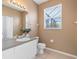 Bathroom with tiled floor and window providing natural light and ventilation at 2248 Wyndham Palms Way, Kissimmee, FL 34747