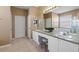 Bathroom featuring double sink vanity with well lit mirror at 2248 Wyndham Palms Way, Kissimmee, FL 34747