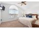 Light-filled bedroom features a large window and ceiling fan, creating a bright and airy space at 2248 Wyndham Palms Way, Kissimmee, FL 34747