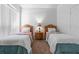 Bedroom features two beds with wooden headboards and a shared nightstand at 2248 Wyndham Palms Way, Kissimmee, FL 34747