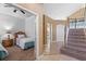 Hallway with view of carpeted stairs and bedroom with two twin beds, neutral tones and a ceiling fan at 2248 Wyndham Palms Way, Kissimmee, FL 34747