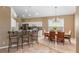 An open-concept kitchen offers seating at the breakfast bar and views to the dining area with a chandelier at 2248 Wyndham Palms Way, Kissimmee, FL 34747