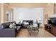 Cozy living room featuring neutral paint, tile floors, and dark brown leather furniture at 2248 Wyndham Palms Way, Kissimmee, FL 34747