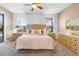 Bright main bedroom featuring neutral tones, and and nightstands with lamps at 2248 Wyndham Palms Way, Kissimmee, FL 34747