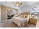 Bright main bedroom featuring neutral tones, ceiling fan, sliding glass doors and plush carpeting at 2248 Wyndham Palms Way, Kissimmee, FL 34747