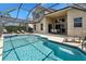 A beautiful backyard screened-in pool, with clear water and outdoor seating, perfect for relaxation and entertainment at 2248 Wyndham Palms Way, Kissimmee, FL 34747