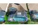 Aerial view of a screened-in pool with a patio and manicured hedges at 2248 Wyndham Palms Way, Kissimmee, FL 34747