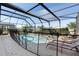 Screened-in pool and patio with lounge chairs, protected by a safety fence at 2248 Wyndham Palms Way, Kissimmee, FL 34747