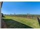 Large backyard featuring an iron fence and beautiful scenery at 2342 Gold Dust Dr, Minneola, FL 34715