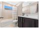 Stylish bathroom featuring a shower-tub combo and vanity with countertop at 2342 Gold Dust Dr, Minneola, FL 34715