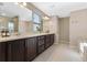 Large bathroom featuring a double vanity sink and plenty of cabinet space at 2342 Gold Dust Dr, Minneola, FL 34715