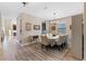 Elegant dining room featuring a formal table with seating for eight, stylish decor, and hardwood floors at 2342 Gold Dust Dr, Minneola, FL 34715