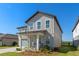 Attractive two-story home with gray siding, a covered porch, and a well-maintained green lawn at 2342 Gold Dust Dr, Minneola, FL 34715