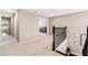 Upstairs hallway with neutral carpet and wooden railing at 2342 Gold Dust Dr, Minneola, FL 34715