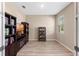 Cozy home office featuring wood floors, built-in bookshelves, and natural light from a window at 2342 Gold Dust Dr, Minneola, FL 34715