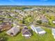 Scenic aerial shot of a lakeside community with manicured lawns and tree-lined streets under a bright sky at 253 Lake Cassidy Dr, Kissimmee, FL 34759