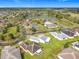 Overhead shot of a serene residential area near a lake, highlighting the community's lush landscapes and winding roads at 253 Lake Cassidy Dr, Kissimmee, FL 34759