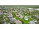 Picturesque aerial scene of a well-planned community featuring verdant lawns, mature trees, and varied home styles with lush landscaping at 253 Lake Cassidy Dr, Kissimmee, FL 34759