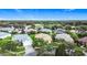 Attractive aerial view showcasing a residential neighborhood with manicured lawns, mature trees, and varied home styles with attached garages at 253 Lake Cassidy Dr, Kissimmee, FL 34759