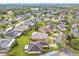 Expansive aerial view of a residential community showcasing well-maintained lawns and various home styles at 253 Lake Cassidy Dr, Kissimmee, FL 34759