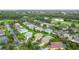 Aerial view showcases homes nestled in a lush, green community near a golf course at 253 Lake Cassidy Dr, Kissimmee, FL 34759