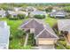 Overhead image of a property boasting manicured lawns, brick pavers, and a clean roof, nestled in a verdant residential setting at 253 Lake Cassidy Dr, Kissimmee, FL 34759