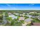 Scenic aerial view of a residential community highlighting well-maintained lawns, mature trees, and a tranquil pond in the background at 253 Lake Cassidy Dr, Kissimmee, FL 34759