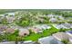 Eye-catching aerial view of residences, lush landscaping, community pond and mature trees in a tranquil residential setting at 253 Lake Cassidy Dr, Kissimmee, FL 34759