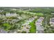 Beautiful aerial view of a lakeside residential community featuring mature trees, a golf course, and varied home styles at 253 Lake Cassidy Dr, Kissimmee, FL 34759