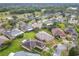 Aerial view of a residential neighborhood showcasing well-maintained homes, lush greenery, and a nearby golf course at 253 Lake Cassidy Dr, Kissimmee, FL 34759