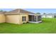 Exterior view of home with a screened-in patio and well-maintained lawn at 253 Lake Cassidy Dr, Kissimmee, FL 34759