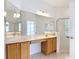 Bright bathroom featuring dual vanity, and a walk-in shower with a glass door at 253 Lake Cassidy Dr, Kissimmee, FL 34759