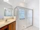 Bathroom showcasing a walk-in shower with glass doors and a marble countertop vanity at 253 Lake Cassidy Dr, Kissimmee, FL 34759