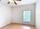 Bright, airy bedroom with wood floors, a ceiling fan, and a window at 253 Lake Cassidy Dr, Kissimmee, FL 34759