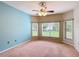 Spacious bedroom featuring carpet, windows and modern ceiling fan at 253 Lake Cassidy Dr, Kissimmee, FL 34759