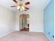Spacious bedroom featuring a ceiling fan and neutral tones with an attached bathroom at 253 Lake Cassidy Dr, Kissimmee, FL 34759