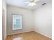 Bedroom features wood floors, ceiling fan, and a window offering natural light at 253 Lake Cassidy Dr, Kissimmee, FL 34759