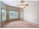 Spacious bedroom featuring carpet, windows and modern ceiling fan at 253 Lake Cassidy Dr, Kissimmee, FL 34759