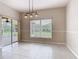 Open dining room with tile flooring and a sliding glass door to the screened porch at 253 Lake Cassidy Dr, Kissimmee, FL 34759