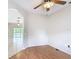 Open room with neutral walls, wood floors, and an archway leading to another room at 253 Lake Cassidy Dr, Kissimmee, FL 34759